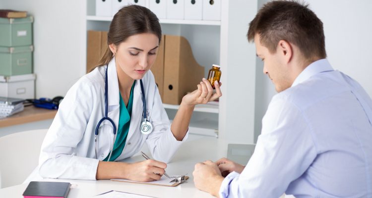47974412 - female medicine doctor prescribing pills to her male patient. healthcare, medical and pharmacy concept.